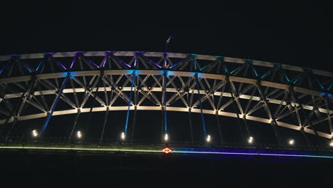 beautiful flashing coloured lights on the sydney harbour bridge from underneath during vivid festival in slow motion