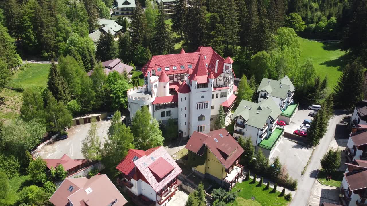 Dracula's Domain from Above: Aerial 4K Drone Shot Showcasing 'House of Dracula' at Poiana Brasov Ski Resort in Carpathian mountains