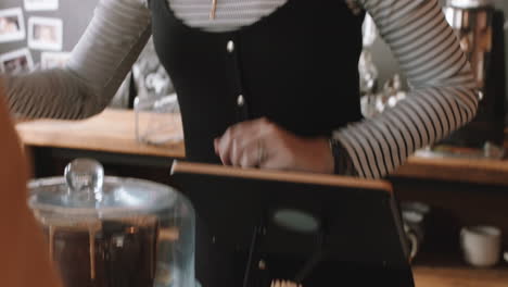 happy barista woman serving customer paying using credit card contactless payment spending money buying coffee in cafe