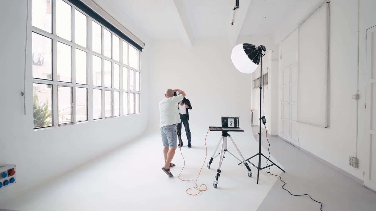 Photographer in a white studio