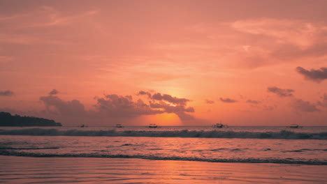 jimbaran beach during scinic colorful golden sunset, bali indonesia, low angle wide angle view seafront