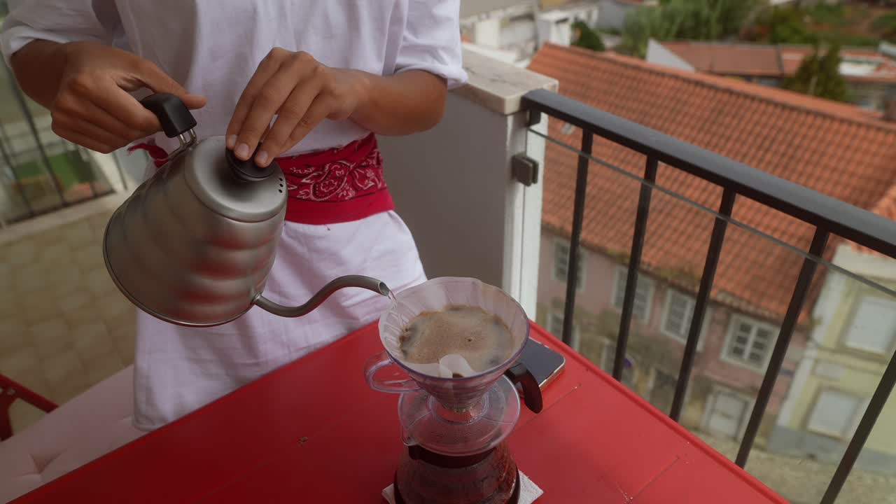 Pouring coffee on a balcony