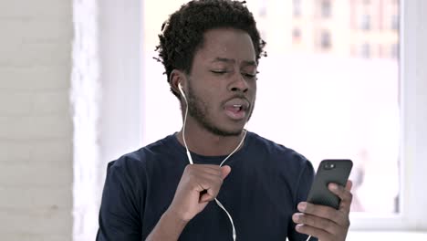 portrait of young african american man listening music with head phones