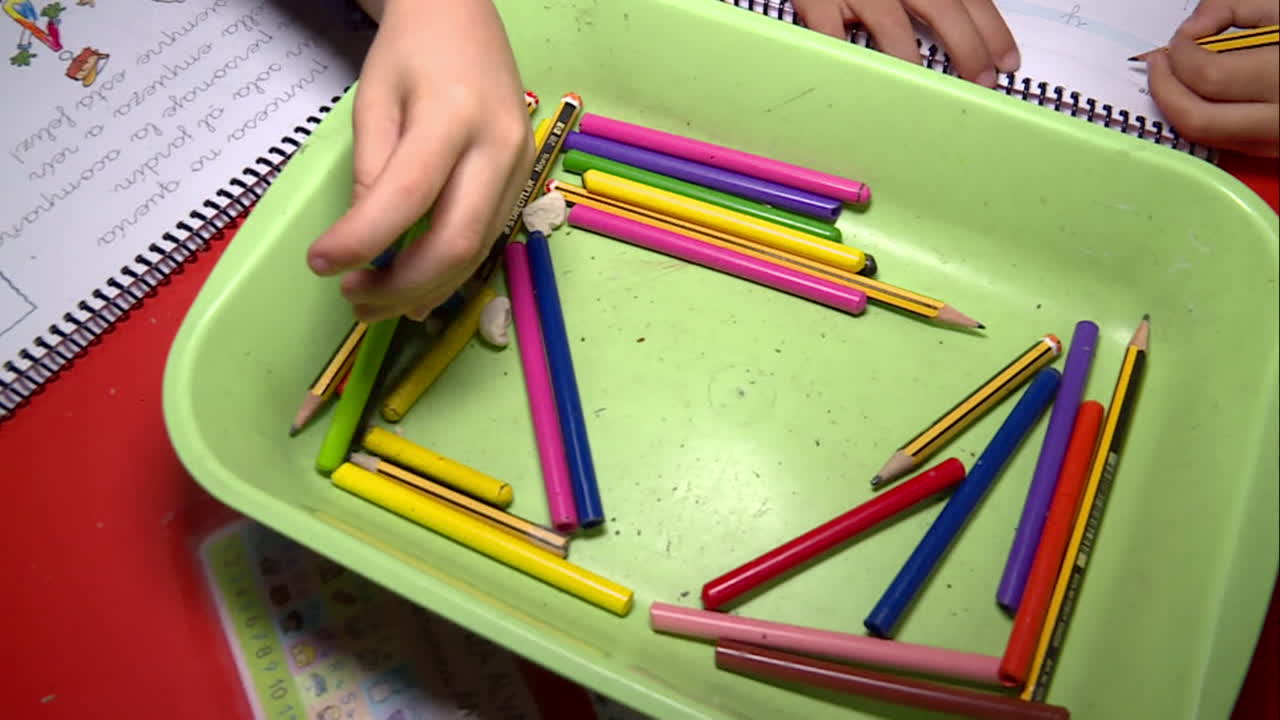 Children doing school work with drawing tools
