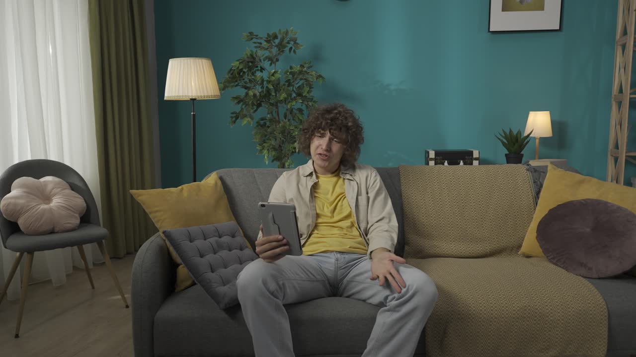 Teenager having a video call on tablet at home