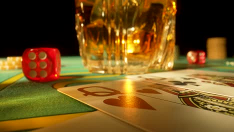 casino game table with whiskey, cards, and dice