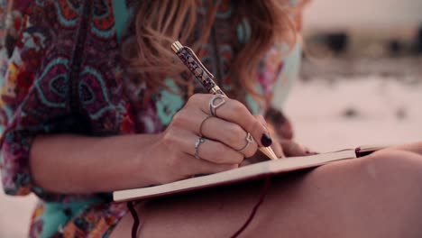 boho girl writing in her diary wearing a floral dress