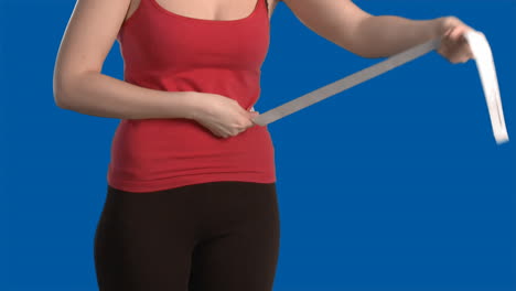 blue screen of woman measuring her waste