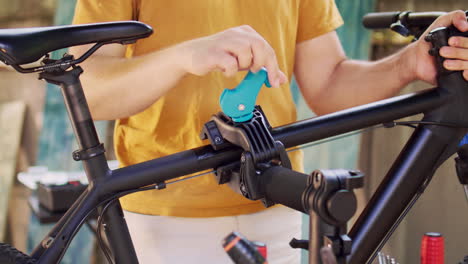 closeup of man fastening bike for repair