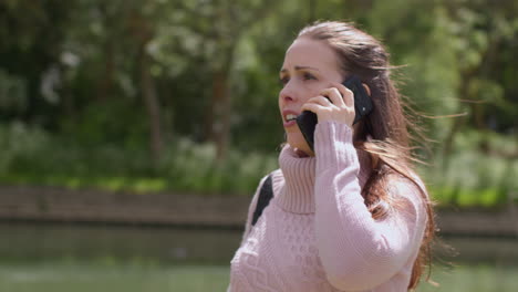 Stressed-Or-Angry-Woman-Outdoors-With-Financial-Worries-About-Cost-Of-Living-Crisis-Debt-And-Paying-Bills-Talking-On-Mobile-Phone-Walking-By-River-1