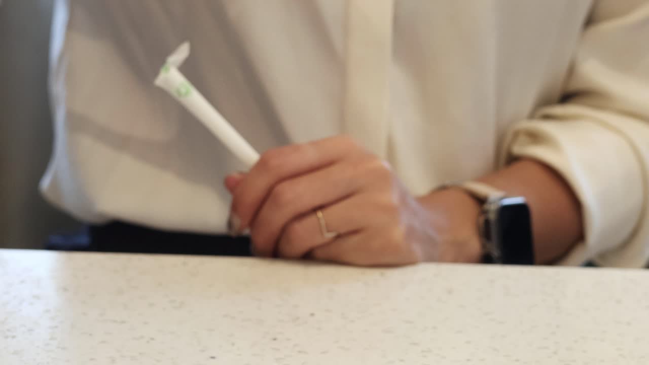 Person grabs drink and straw on counter