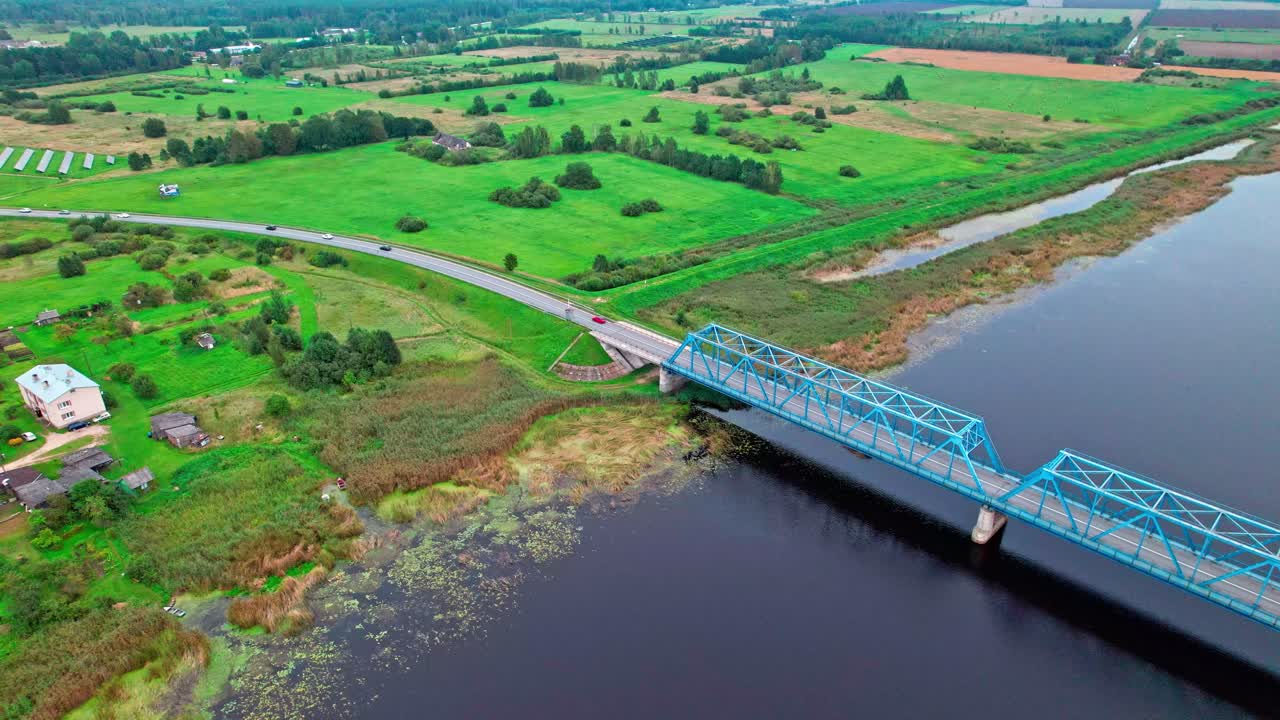 Aerial view of a bridge and lush landscape in Latvia