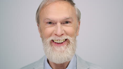 Smiling-man-moving-eyebrows-in-studio.-Mature-male-model-posing-to-camera.