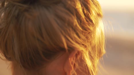 beautiful shot of a woman staring at the ocean at sunset, beautiful scenery, dress and details