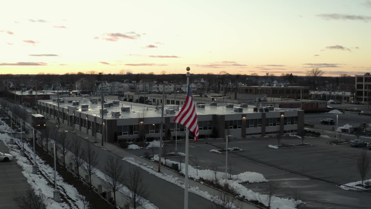 Orbiting aerial view of a USA flag blowing in the wind - parallax view