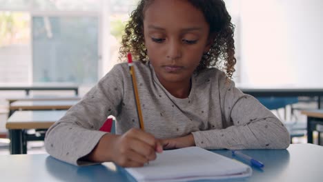 african american girl doing homework in class