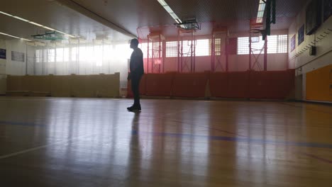 Male-Standing-Looking-Around---Strong-Athletic-Muscular-Black-Man-Standing-On-Basketball-Court-Looking-Around-In-4K