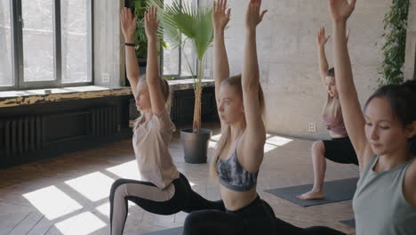women practicing yoga poses in a studio