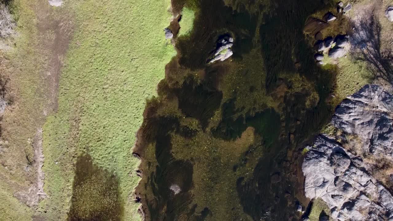 Cenital shot moving slow along a stunning river in Cordoba Argentina