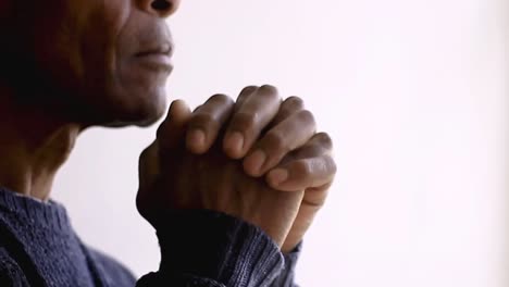 man praying to god with hands together caribbean man praying with background with people stock footage