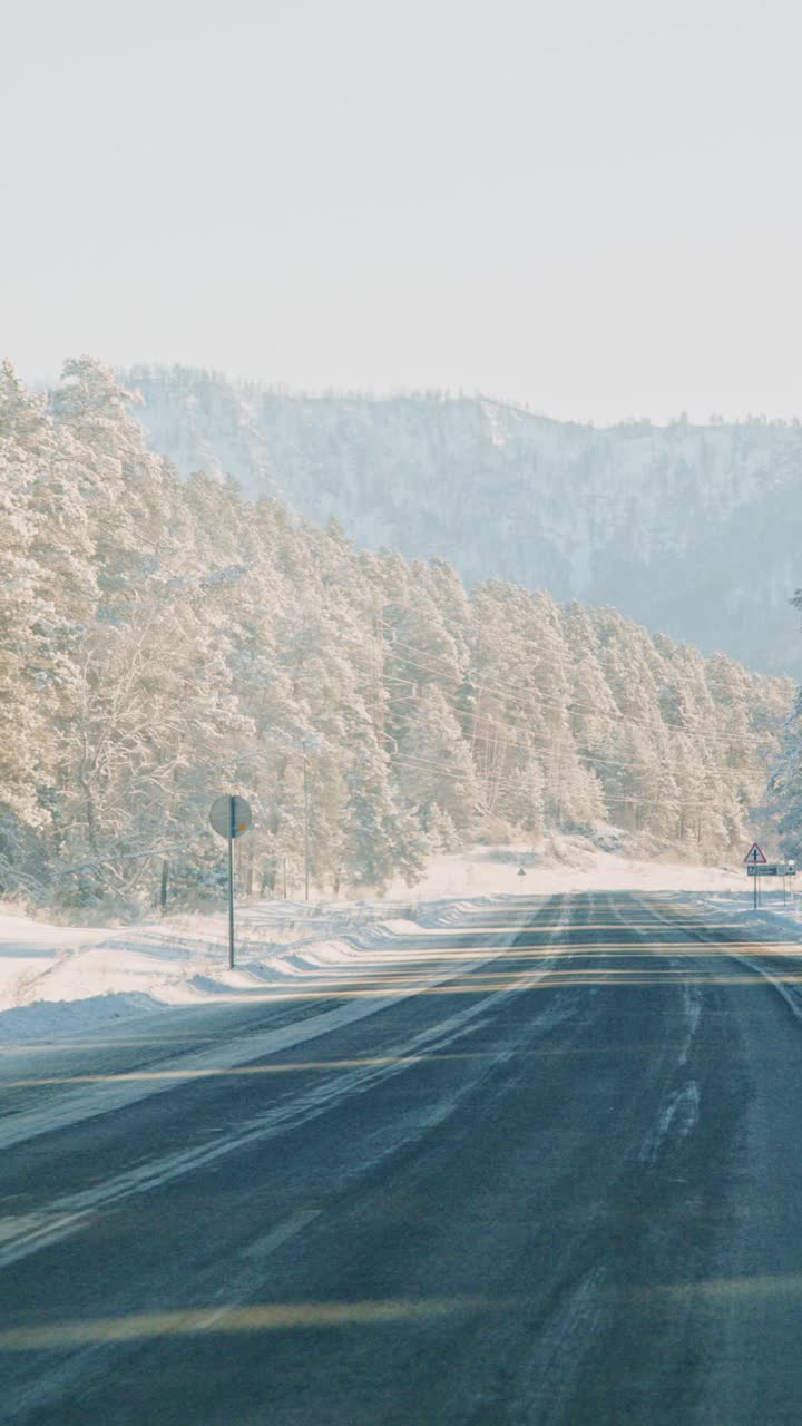 Beautiful winter landscape along snow-covered mountain road in early morning light