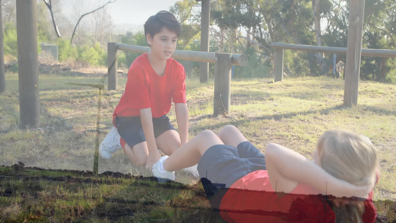 Exercising outdoors, children in red shirts on grassy field, enjoying animation