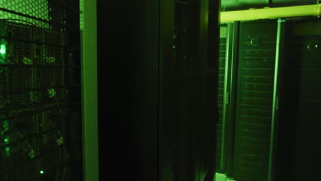 green control lights and data processing on computer servers in tech room