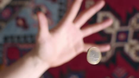 slowmotion flipping coin gets in focus