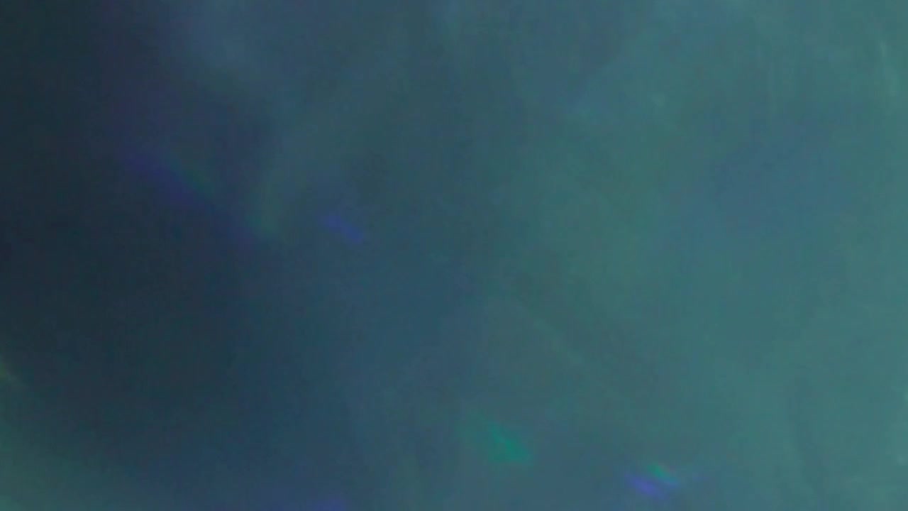 Abstract Light Leaks and Prism Reflections on Dark Background