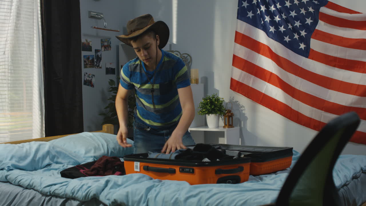 Teenage boy packing for a trip