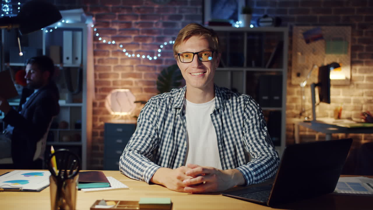 Smiling Man Working Late at Home Office