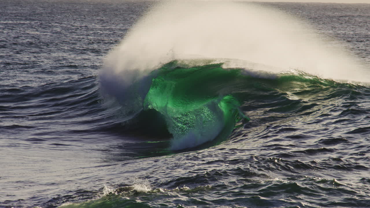 Rippled ocean wave texture glowing green with barrel crashing down, slow motion backdrop background
