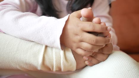 cute baby girl playing with her toes