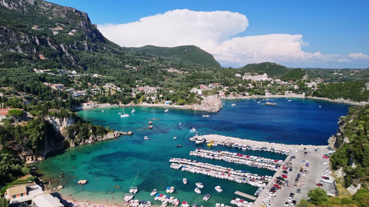 Scenic aerial view of coastal town, vibrant sea, lively summer atmosphere