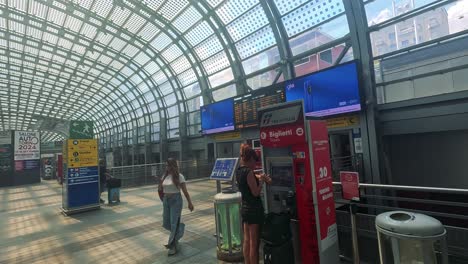 travelers navigate the bustling turin train station