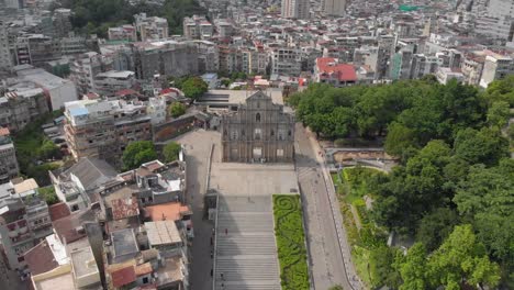 reversing tilt reveal aerial view of ruins of saint paul's, macau and surrounding area