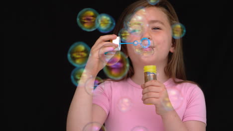 happy girl playing with bubbles