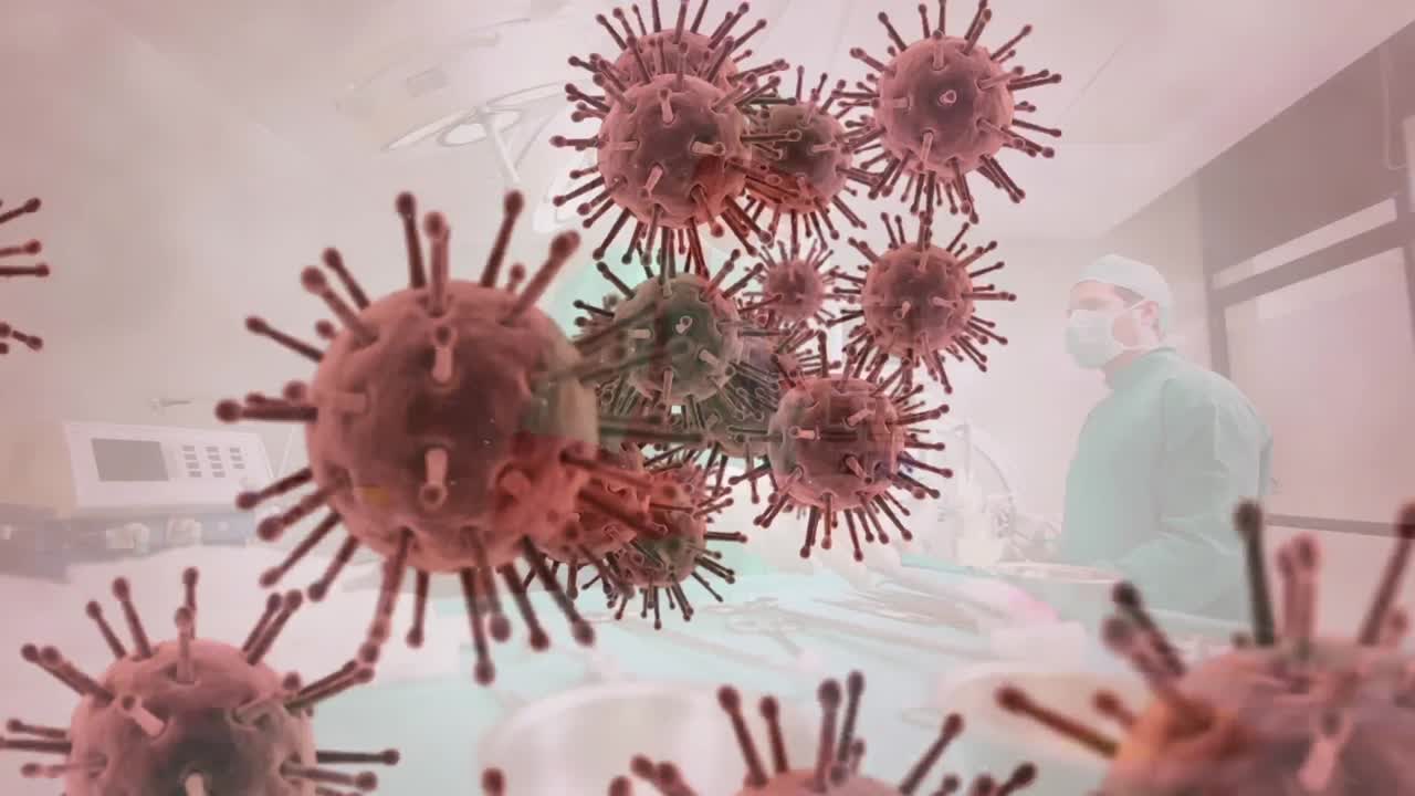 Animation of covid 19 cells floating over surgeons in face masks