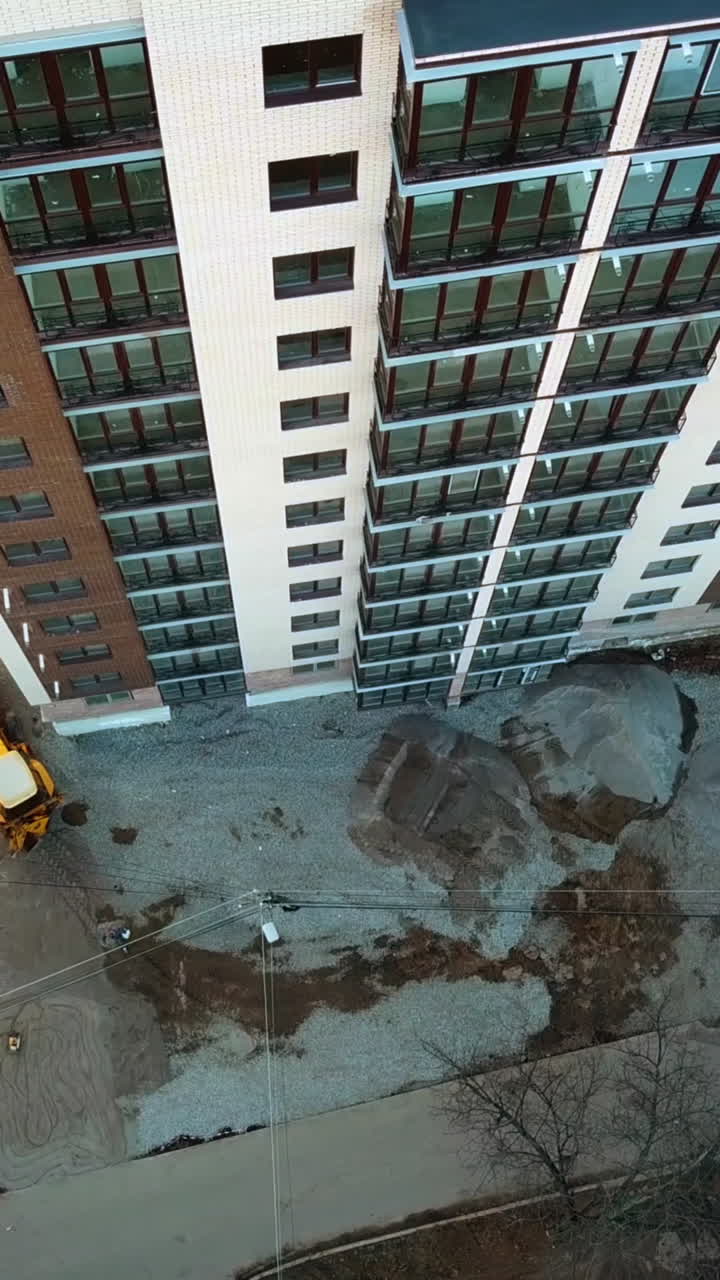 New house construction. Large apartment buildings construction in new district Vertical video