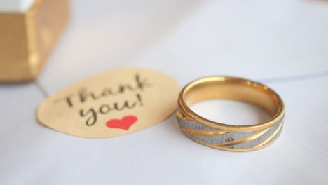 gold wedding ring with thank you note