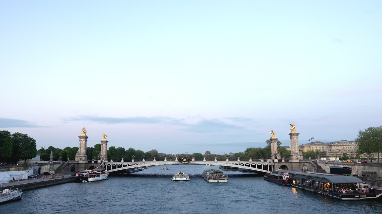 Wide and Cinematic view of the Pont Alexandre III bridge during spring sunset in Paris