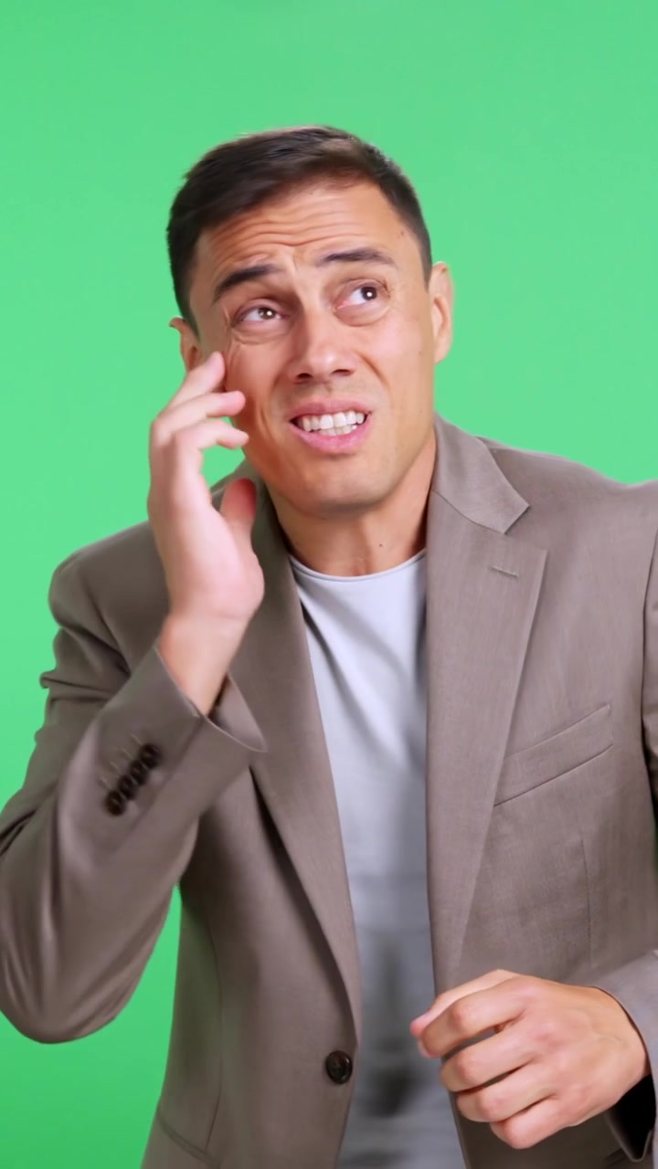 Scared and frightened businessman on green screen