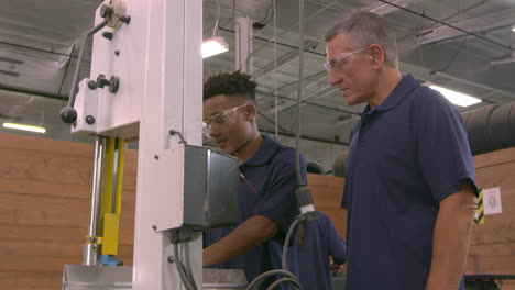 carpenter and male apprentice using jigsaw shot on r3d