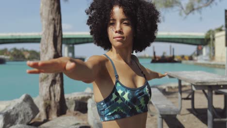 chica confiada entrenando en la costa del río