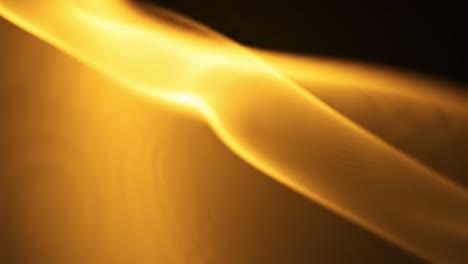 soft golden waves of light sway gently through darkness, producing a calming and mesmerizing effect. the fluid movement captivates and draws the viewer into a tranquil atmosphere.
