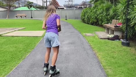 woman rollerblading and frisbee in park