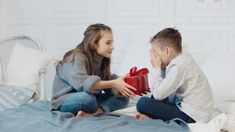 surprised boy getting present box in new year apartment.