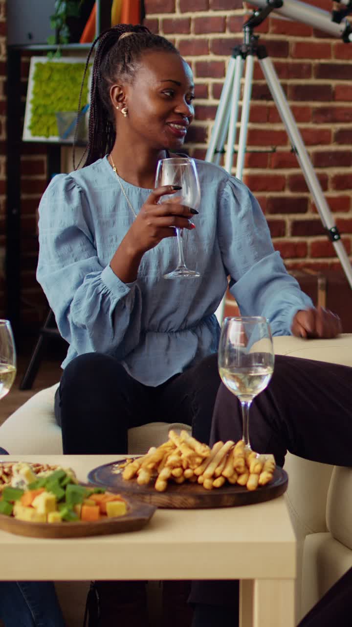 Vertical video Employees celebrating business success at work, gathered at home to toast wine drinks