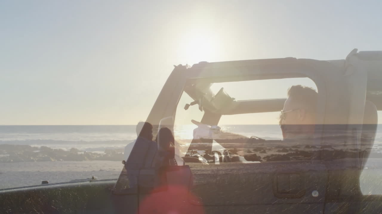 Driving convertible, person overlaid with couple watching beach sunset animation