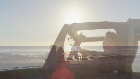 driving convertible, person overlaid with couple watching beach sunset animation